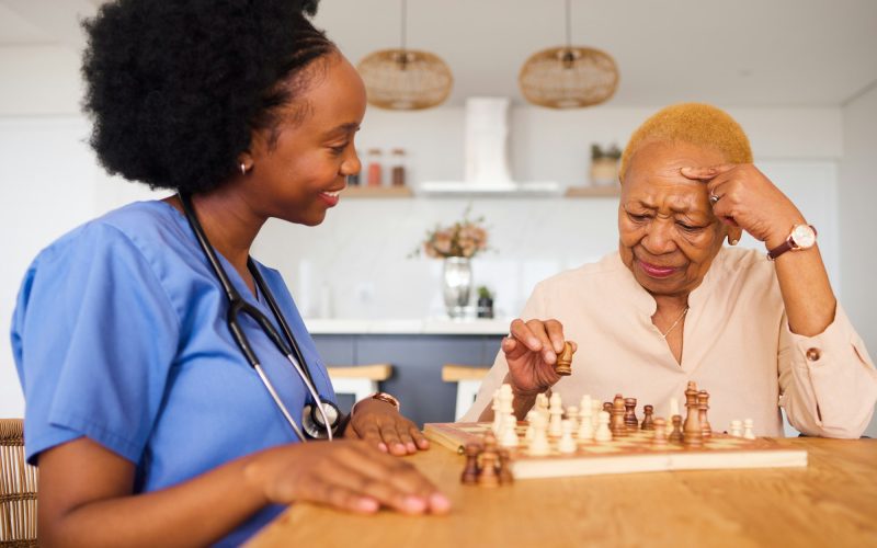 Black people, nurse and thinking in elderly care for chess, fun or social activity together at home