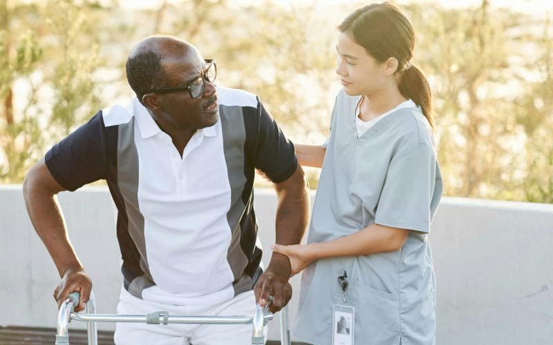 Caregiver helping man with disability